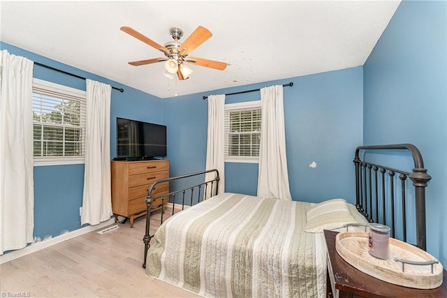 bedroom with ceiling fan and light hardwood / wood-style flooring