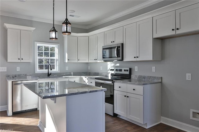 kitchen featuring a center island, white cabinetry, stainless steel appliances, and stone counters