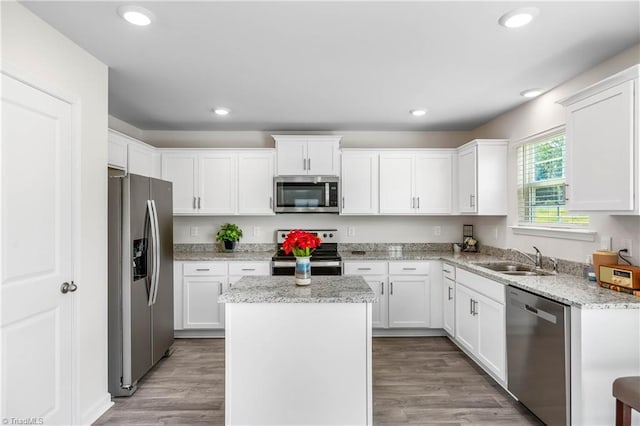 141 Nova Ln, King, NC 27021 - kitchen featuring appliances with stainless steel finishes, a sink, a center island, white cabinetry, and recessed lighting