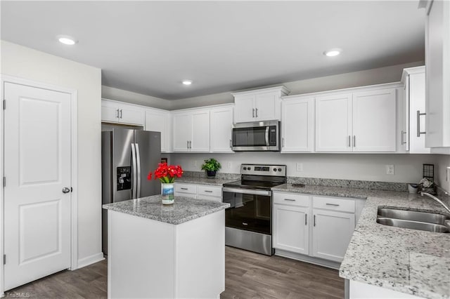 141 Nova Ln, King, NC 27021 - kitchen featuring appliances with stainless steel finishes, a sink, white cabinets, light stone counters, and recessed lighting