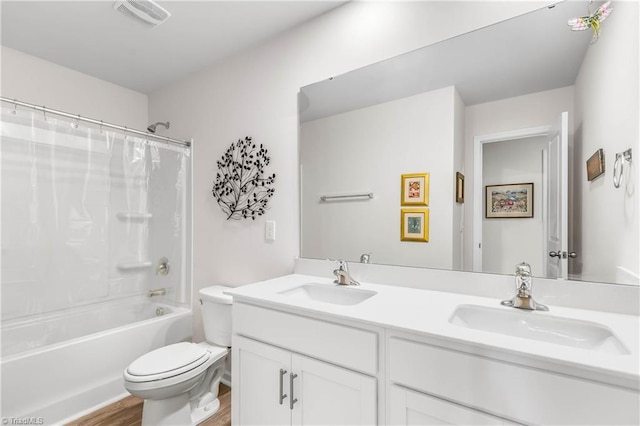 141 Nova Ln, King, NC 27021 - bathroom featuring double vanity, toilet, wood finished floors, and shower / tub combo with curtain
