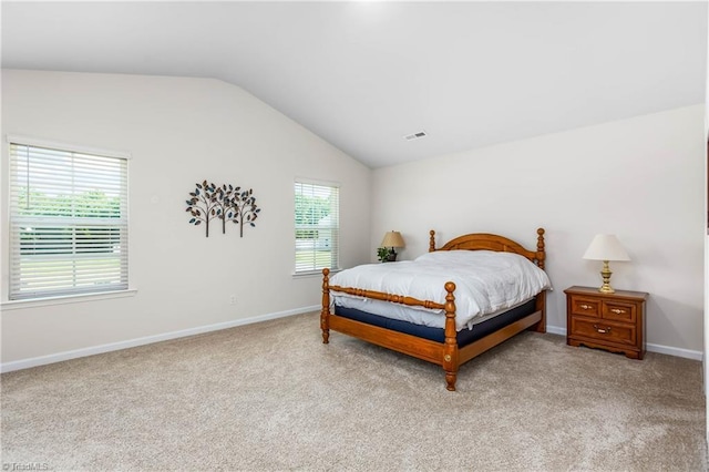 141 Nova Ln, King, NC 27021 - bedroom with vaulted ceiling, light carpet, and baseboards