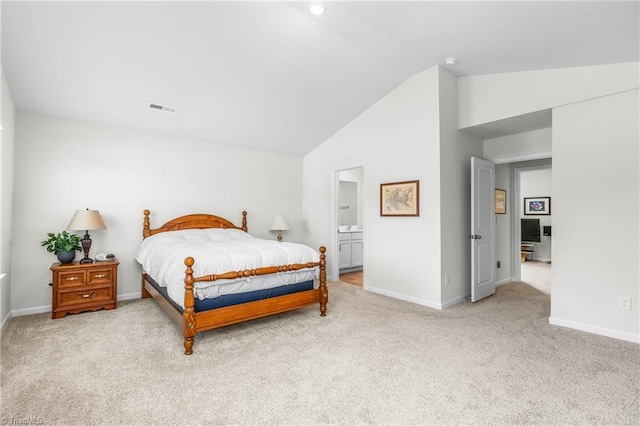 141 Nova Ln, King, NC 27021 - carpeted bedroom with lofted ceiling, baseboards, and ensuite bath