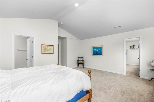 141 Nova Ln, King, NC 27021 - bedroom featuring a walk in closet, lofted ceiling, carpet flooring, baseboards, and a closet