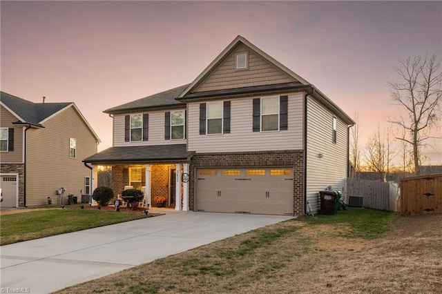 view of front of house with a yard and a garage