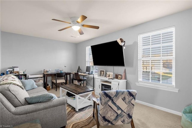 carpeted living room with ceiling fan