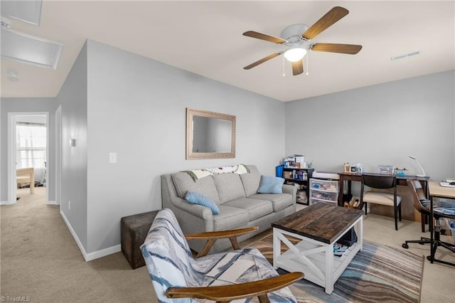 carpeted living room with ceiling fan