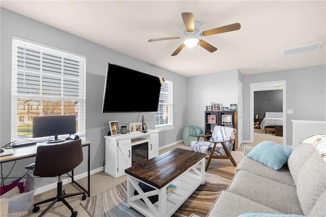 carpeted living room featuring ceiling fan