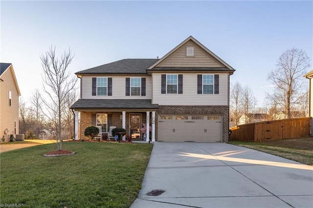 view of front facade featuring a front yard, central AC, and a garage