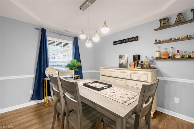 dining space with dark hardwood / wood-style flooring