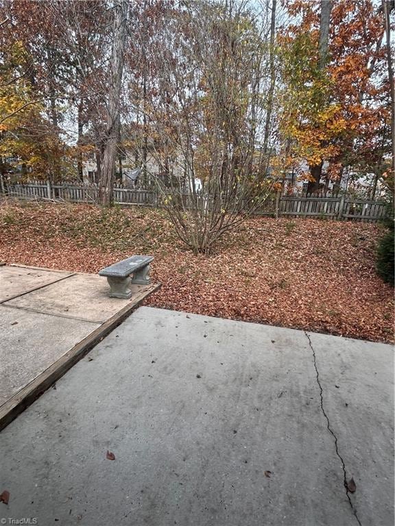 view of yard featuring fence and a patio