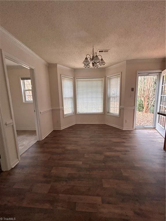 interior space with dark wood-style floors, visible vents, crown molding, and an inviting chandelier