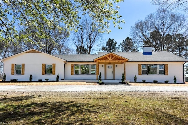 ranch-style home with a chimney