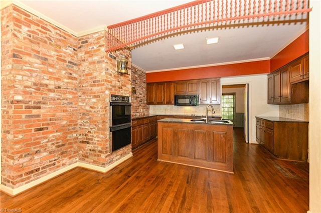 1300 Hobbs Rd, Greensboro, NC 27410 - kitchen featuring a sink, black appliances, an island with sink, dark wood-style floors, and dark countertops