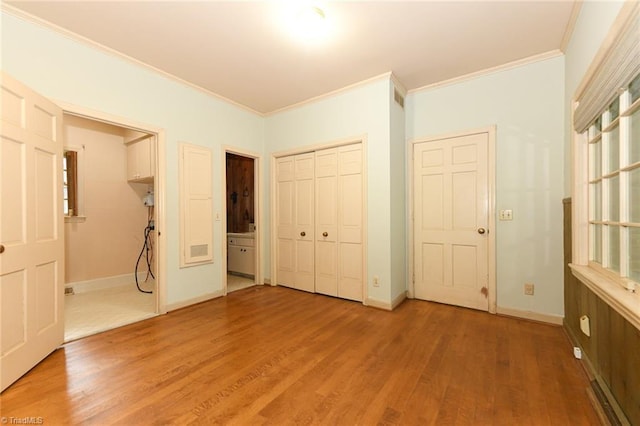 1300 Hobbs Rd, Greensboro, NC 27410 - unfurnished bedroom with crown molding, light wood-style floors, a closet, baseboards, and ensuite bathroom