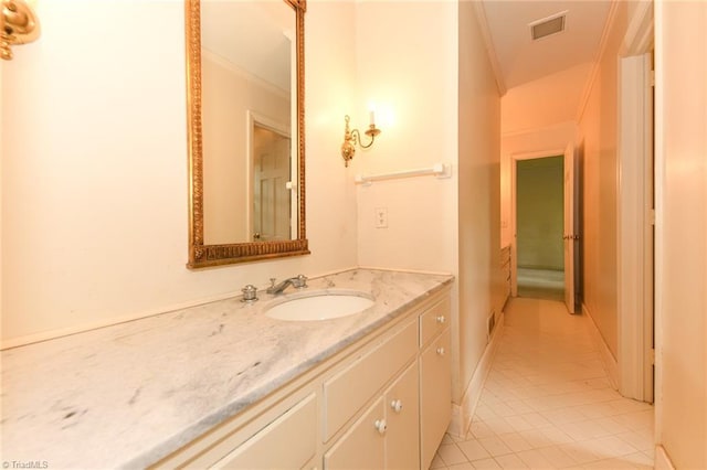 1300 Hobbs Rd, Greensboro, NC 27410 - bathroom with tile patterned flooring, vanity, and ornamental molding