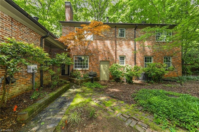 1300 Hobbs Rd, Greensboro, NC 27410 - back of property featuring a chimney and brick siding