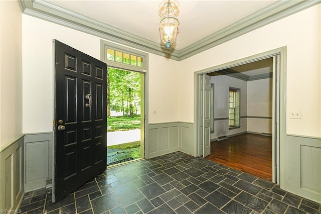 1300 Hobbs Rd, Greensboro, NC 27410 - foyer with wainscoting, stone tile floors, ornamental molding, and a decorative wall
