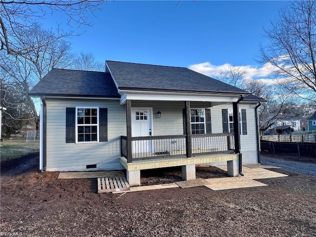 view of front of house with crawl space, covered porch, and roof with shingles