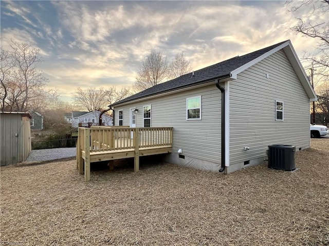 rear view of house featuring crawl space, a deck, and central AC unit