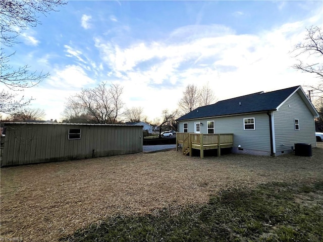 view of yard featuring a deck and central AC