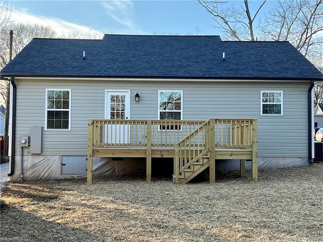 rear view of house featuring crawl space, roof with shingles, and a wooden deck