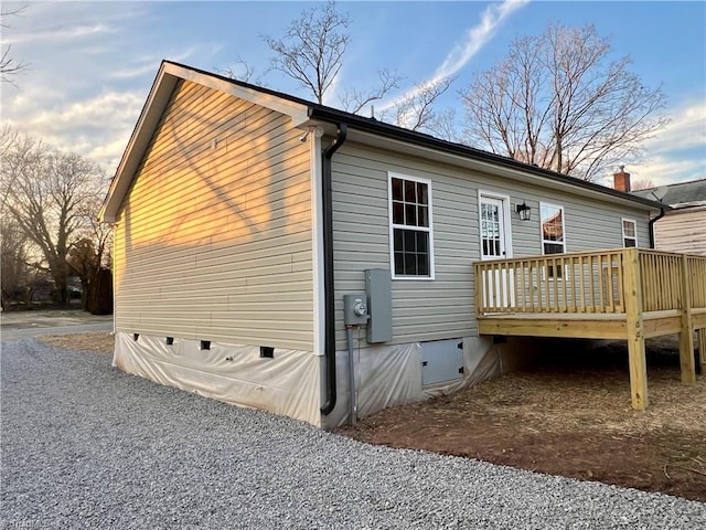 back of property with crawl space and a wooden deck