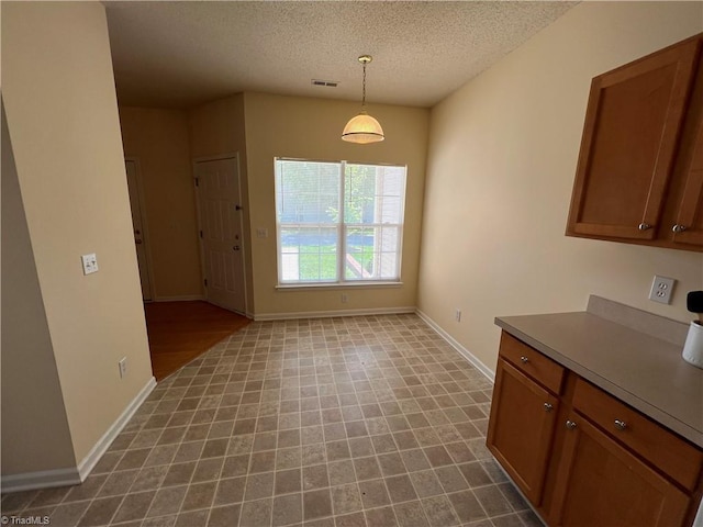3931 Fountain Village Ln, High Point, NC 27265 - unfurnished dining area with baseboards and a textured ceiling