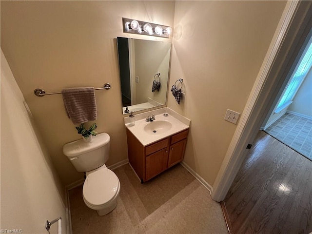 3931 Fountain Village Ln, High Point, NC 27265 - bathroom featuring toilet, vanity, baseboards, and wood finished floors