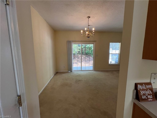 3931 Fountain Village Ln, High Point, NC 27265 - unfurnished dining area featuring carpet flooring, a chandelier, baseboards, and a textured ceiling