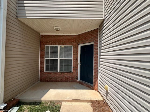 3931 Fountain Village Ln, High Point, NC 27265 - view of exterior entry with brick siding and a patio area