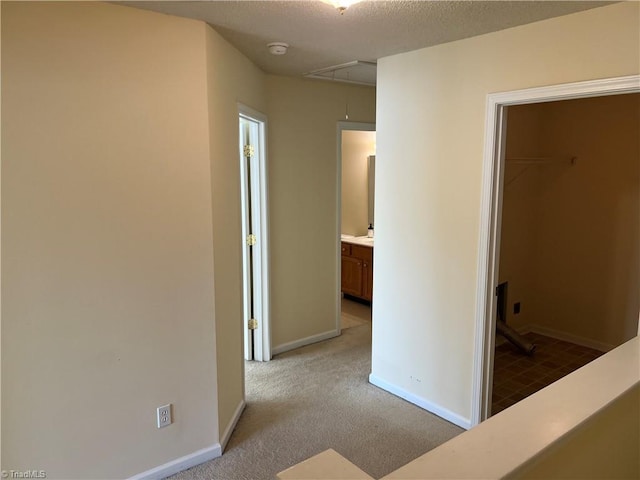 3931 Fountain Village Ln, High Point, NC 27265 - hallway featuring attic access, light colored carpet, and baseboards