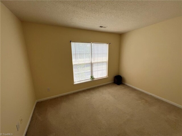 3931 Fountain Village Ln, High Point, NC 27265 - carpeted empty room featuring a textured ceiling and baseboards