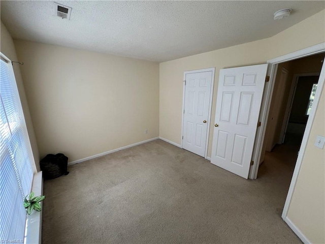 3931 Fountain Village Ln, High Point, NC 27265 - unfurnished bedroom featuring carpet flooring, a textured ceiling, and baseboards