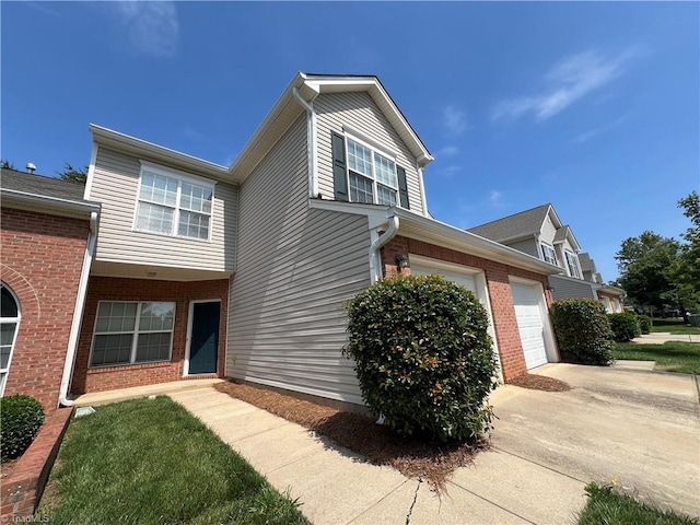 3931 Fountain Village Ln, High Point, NC 27265 - view of front of home with brick siding, concrete driveway, and an attached garage