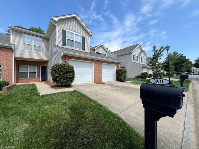 3931 Fountain Village Ln, High Point, NC 27265 - view of front facade with concrete driveway, brick siding, a front yard, and a garage