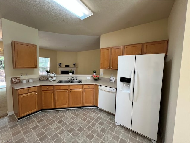 3931 Fountain Village Ln, High Point, NC 27265 - kitchen featuring white appliances, a sink, light countertops, and brown cabinetry