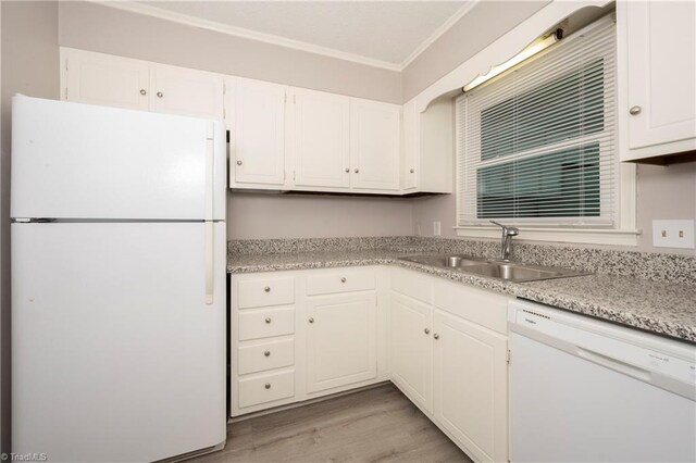 kitchen with white appliances, white cabinets, sink, light hardwood / wood-style flooring, and ornamental molding