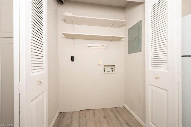 clothes washing area with electric panel, hookup for an electric dryer, washer hookup, and light wood-type flooring