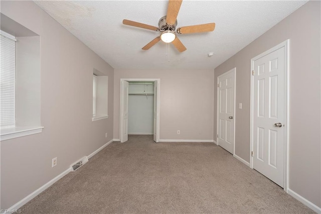 unfurnished bedroom with light carpet and ceiling fan