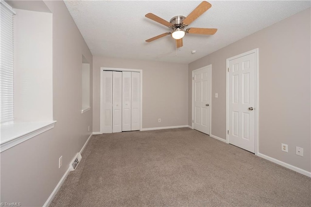 unfurnished bedroom featuring light carpet and ceiling fan