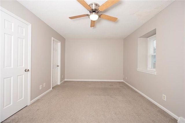 unfurnished room with light carpet and ceiling fan