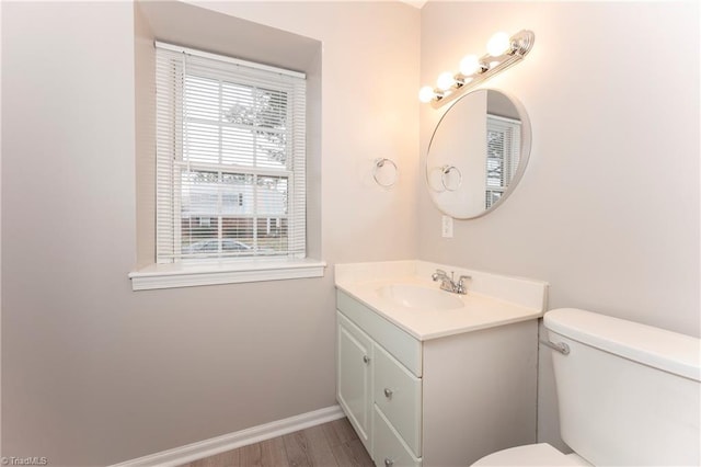 bathroom featuring hardwood / wood-style flooring, vanity, and toilet