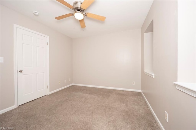 unfurnished room featuring ceiling fan and light colored carpet