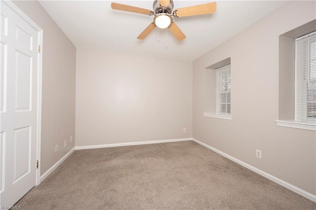 carpeted spare room with ceiling fan