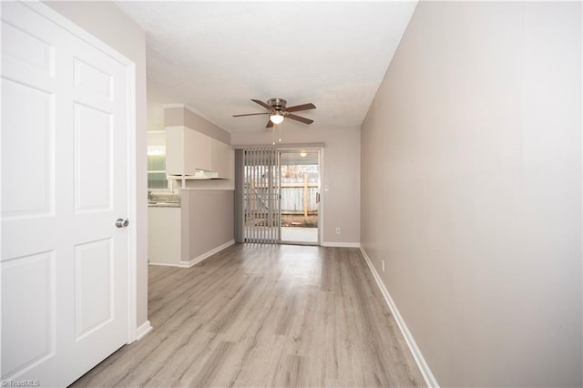 unfurnished living room featuring ceiling fan and light wood-type flooring