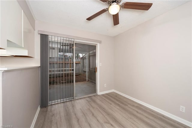 spare room with light hardwood / wood-style floors and ceiling fan