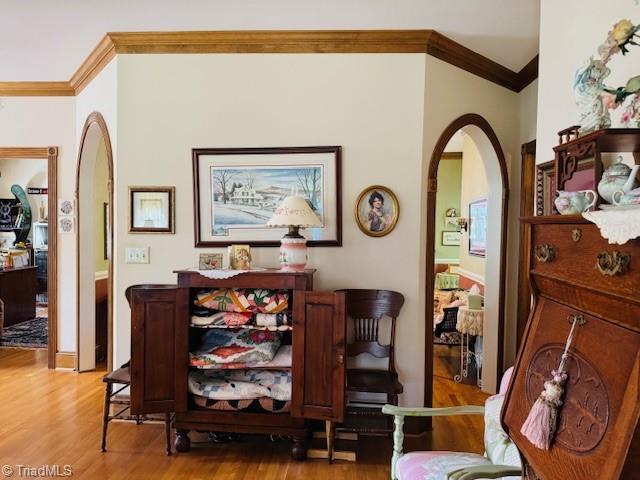526 Bob Rainey Trl, Burlington, NC 27217 - dining room featuring ornamental molding, arched walkways, and wood finished floors
