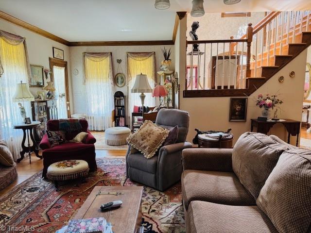 526 Bob Rainey Trl, Burlington, NC 27217 - living area with stairway, wood finished floors, and crown molding