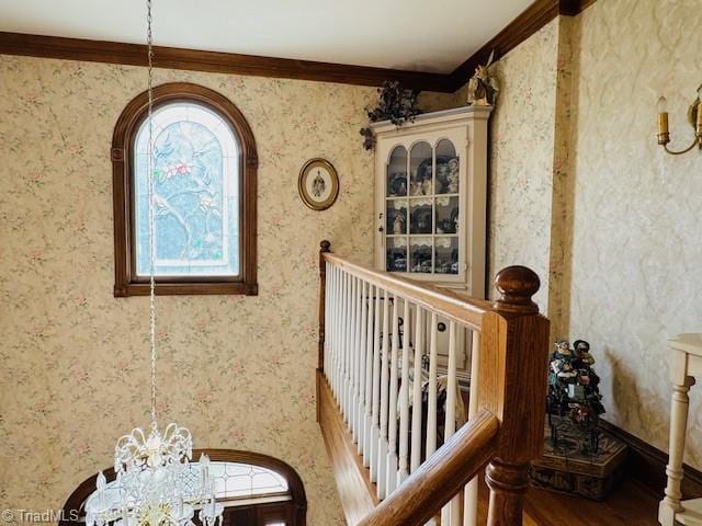 526 Bob Rainey Trl, Burlington, NC 27217 - stairway featuring crown molding, a chandelier, and wood finished floors